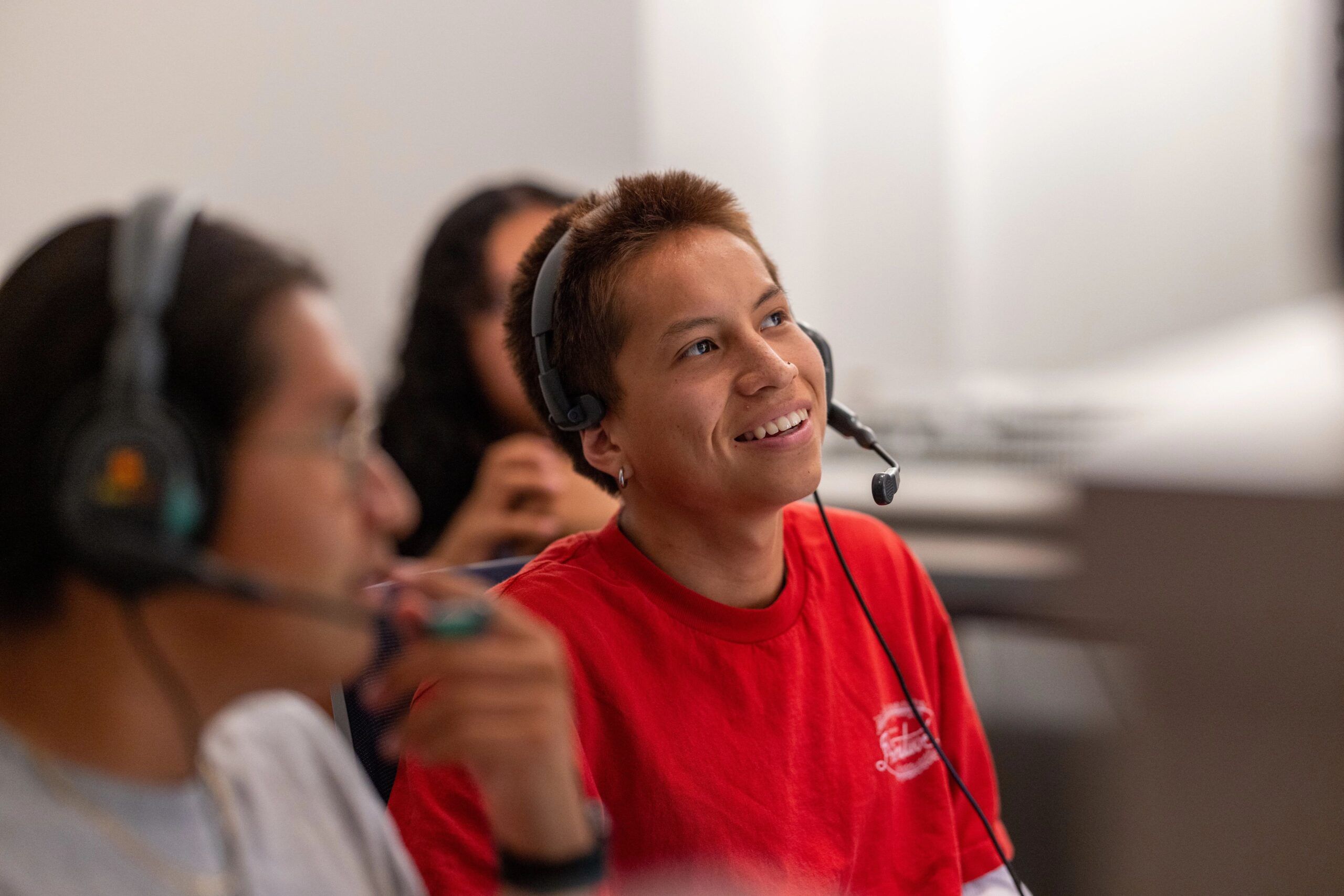 An NAU student grins while working in the Indigenous Youth Media Workshop.