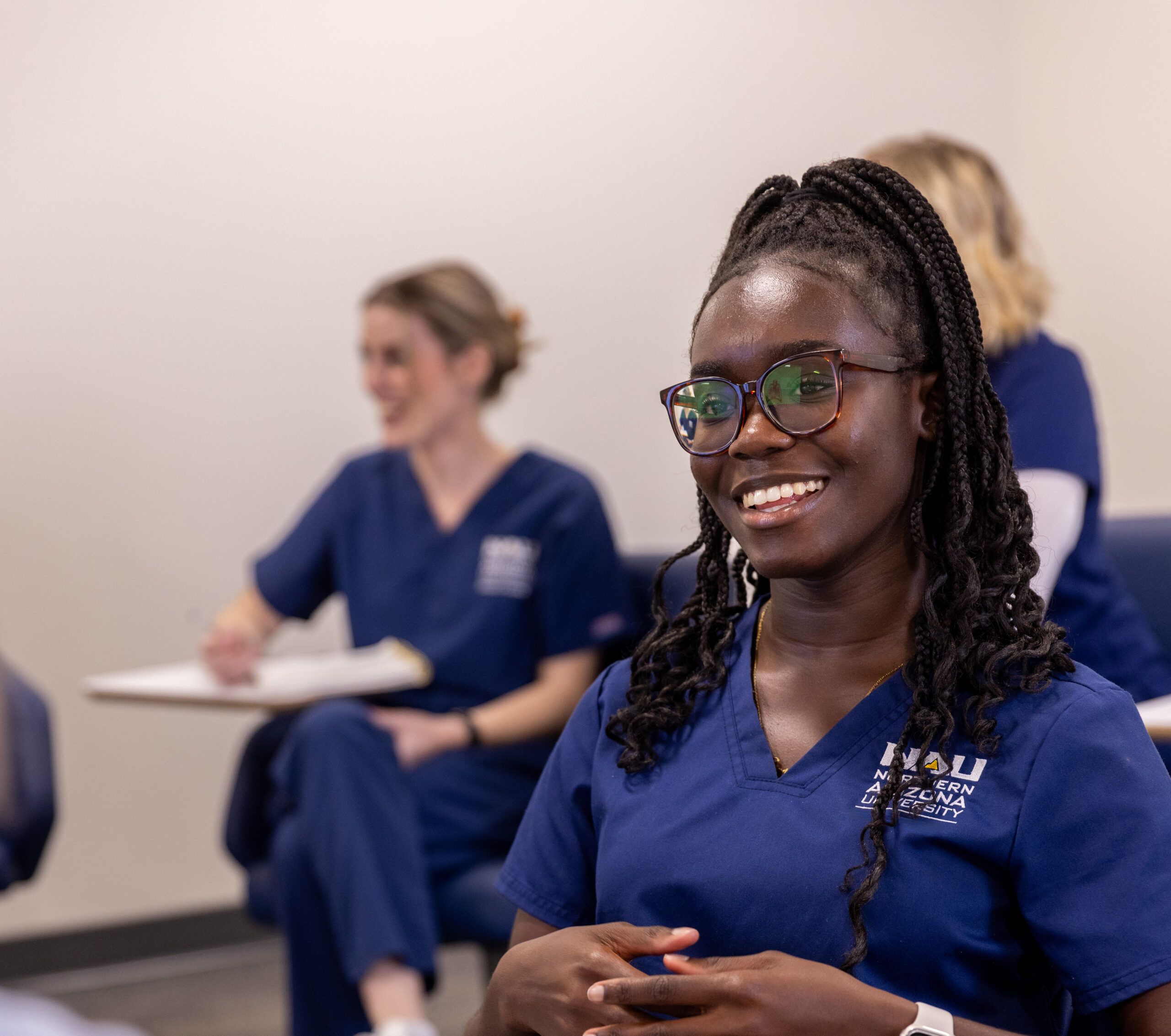 An NAU College of Nursing student smiles while talking to classmates on the Flagstaff Campus.