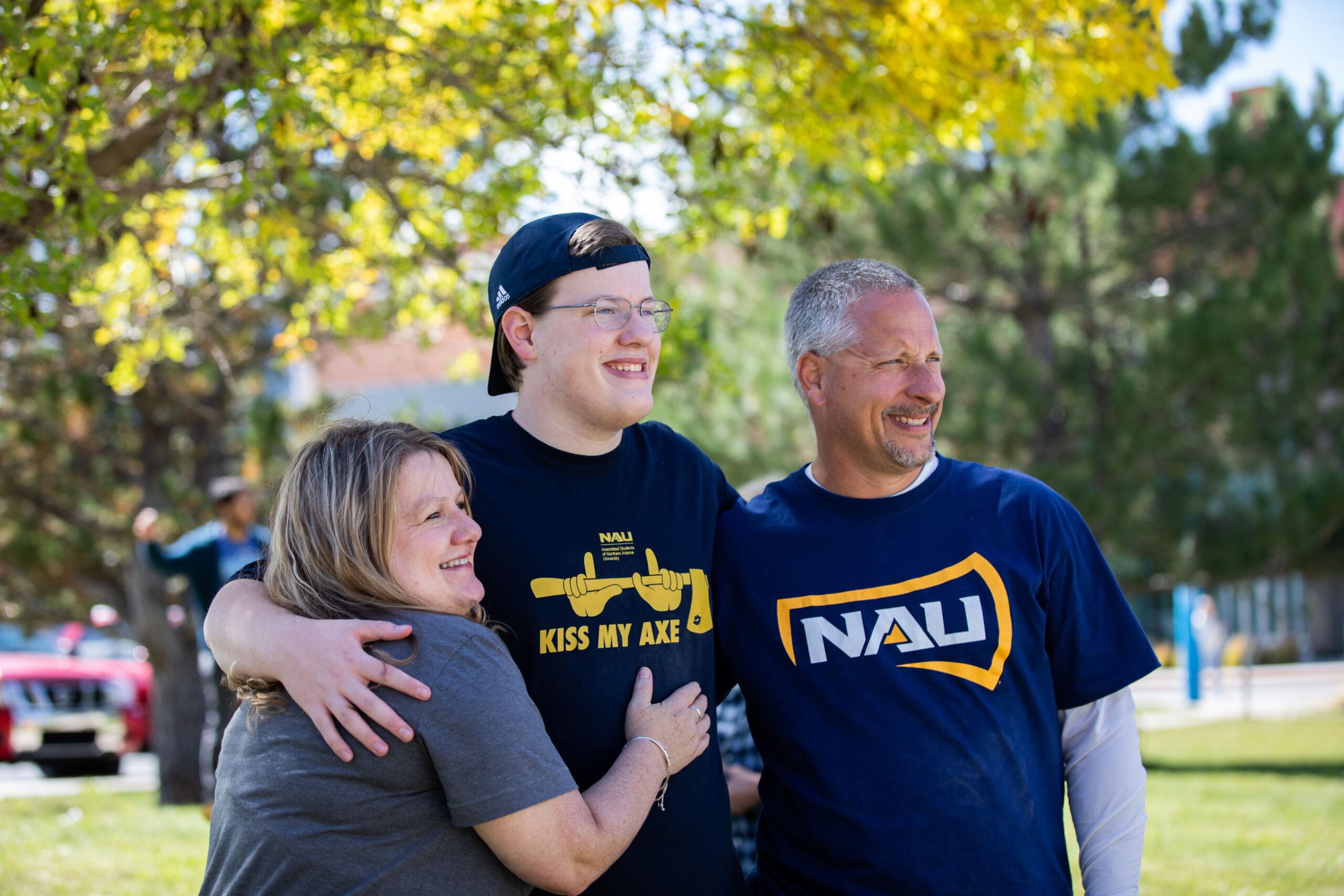 A NAU student takes a photo with their parents at Flagstaff campus.