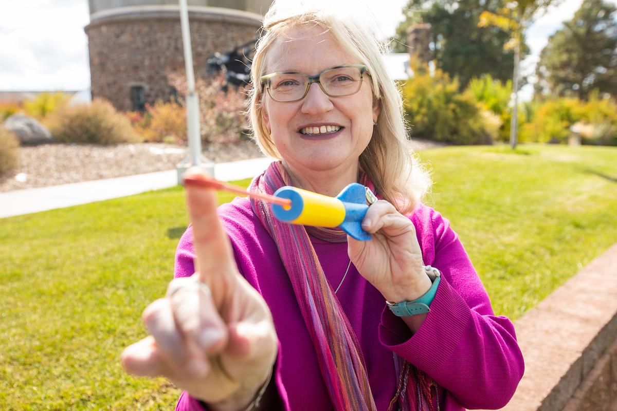 Marti Canipe holding a toy rocket.