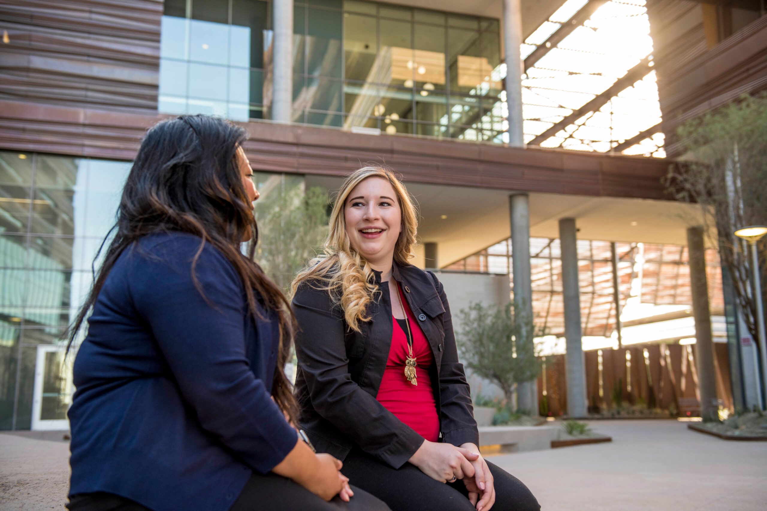 Students sit outside on campus at the Phoenix Bioscience Core.
