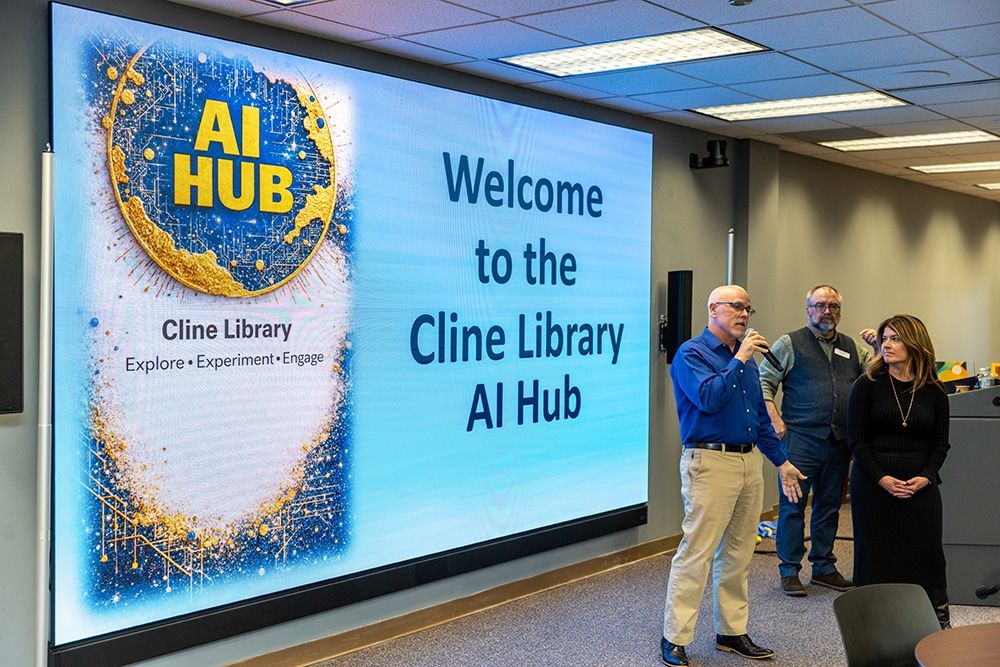 A sign for the AI Hub at Cline Library with John Gartin on the microphone