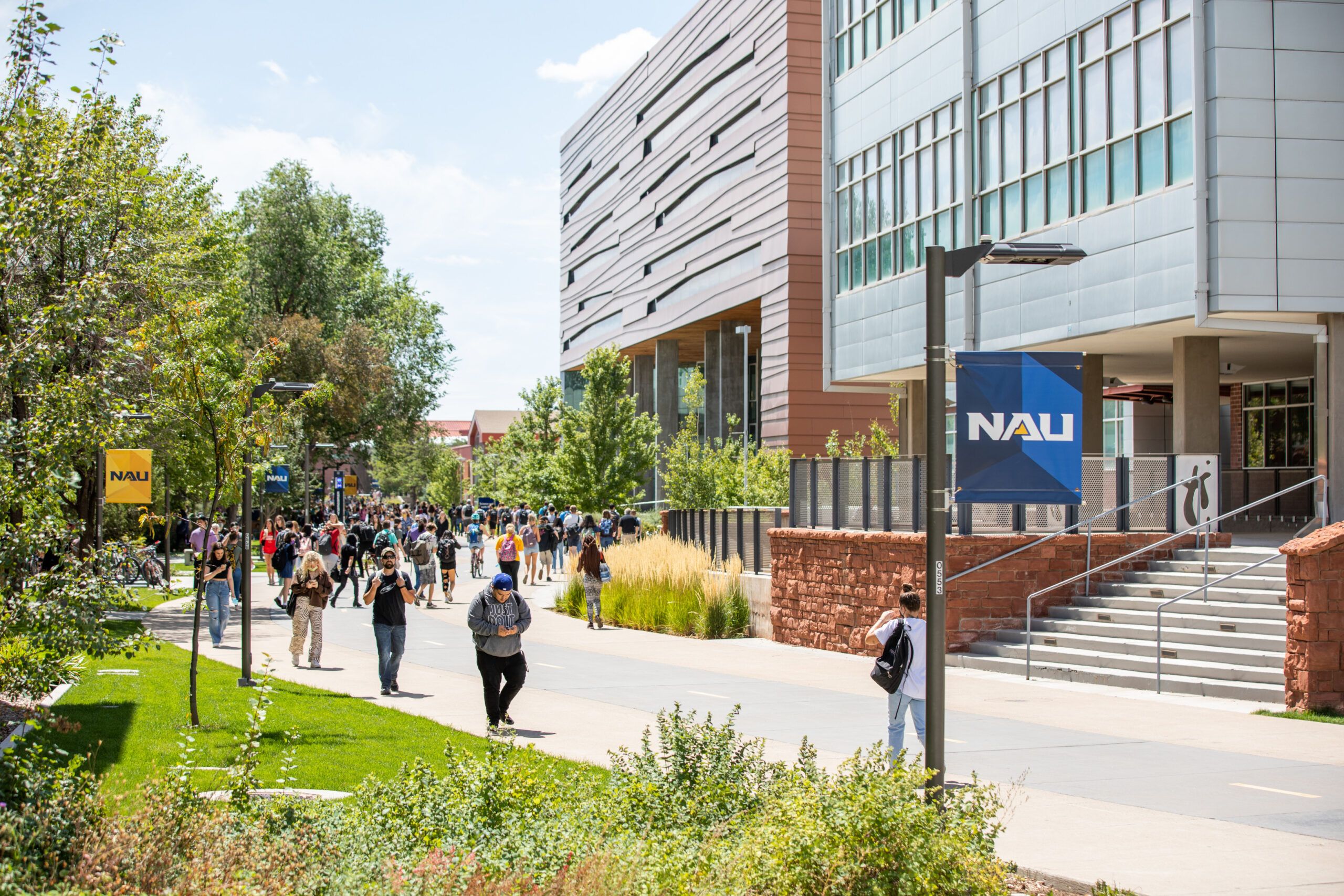 A bustling day on campus with students walking on the pedway of north campus at NAU.
