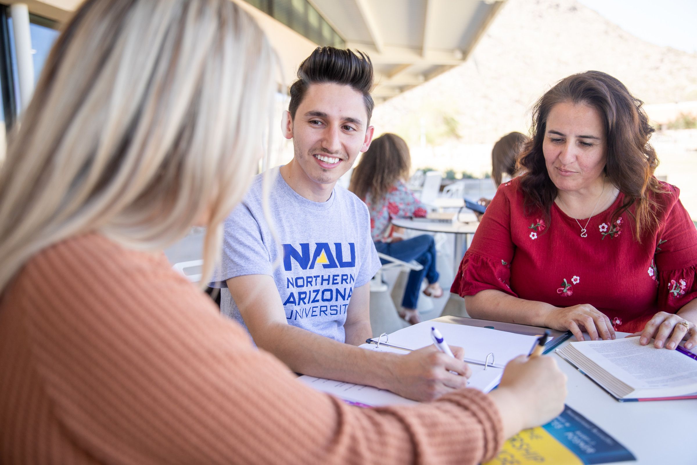 Happy NAU statewide students sitting at a table.