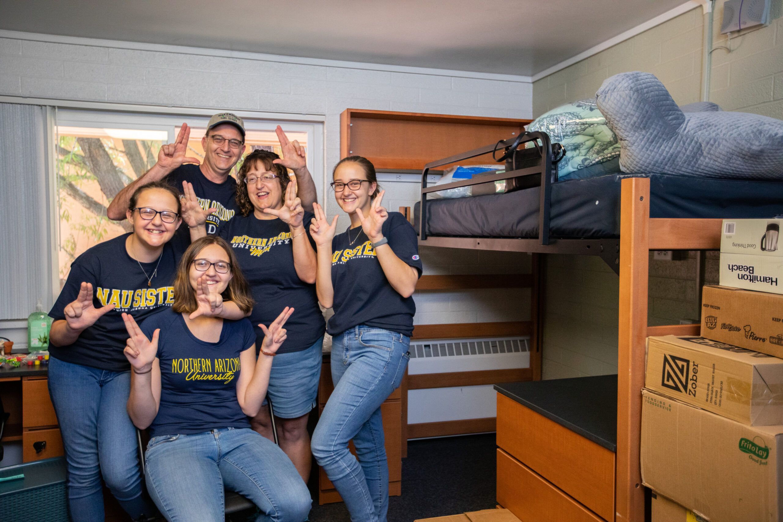 A family moves their new NAU student into the dorms on Flagstaff campus.