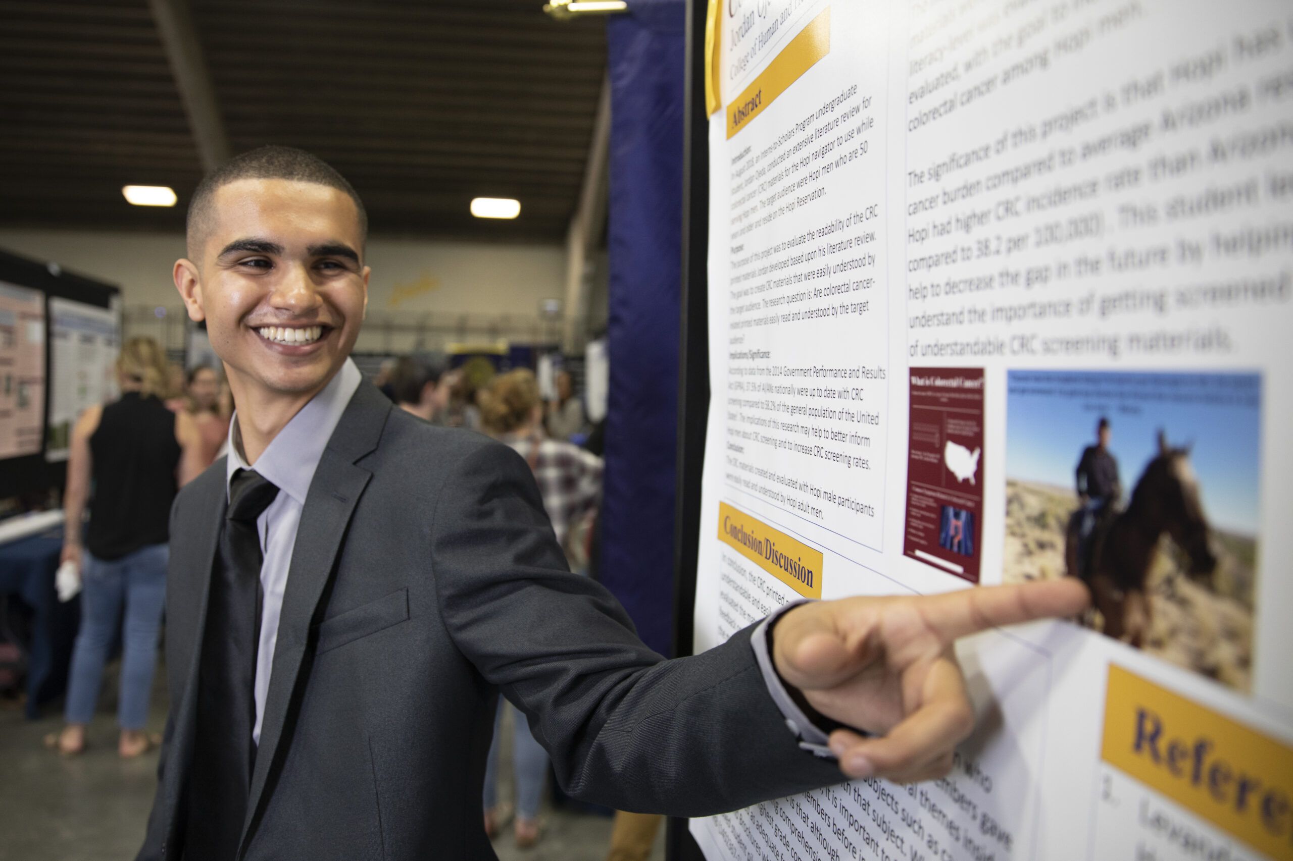 An NAU Social and Behavioral Sciences student presents his research at the Undergraduate Symposium.