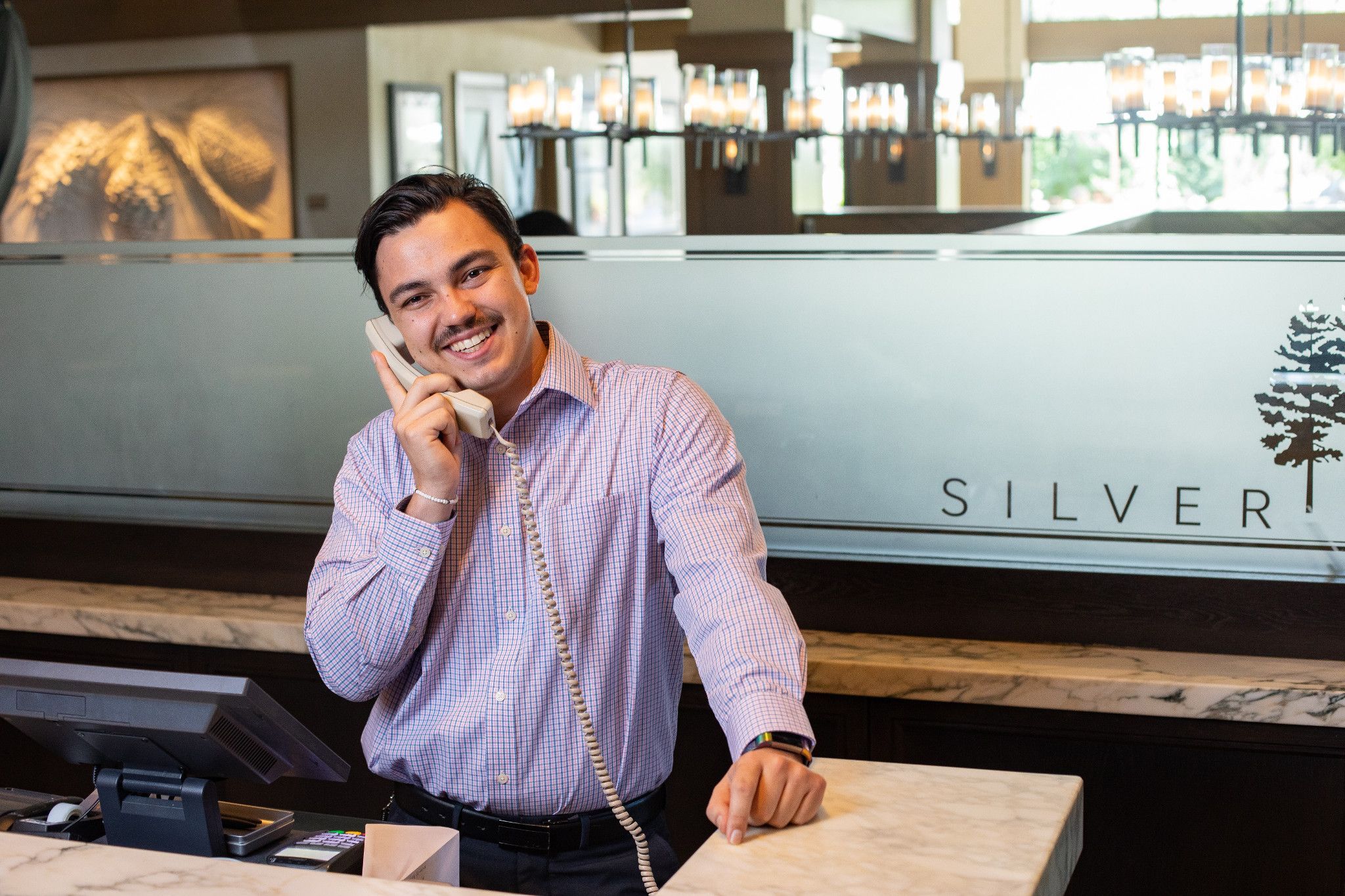 An NAU Hotel and Restaurant Management student trains while working the front desk at Silver Pines, a high-end restaurant in Flagstaff.