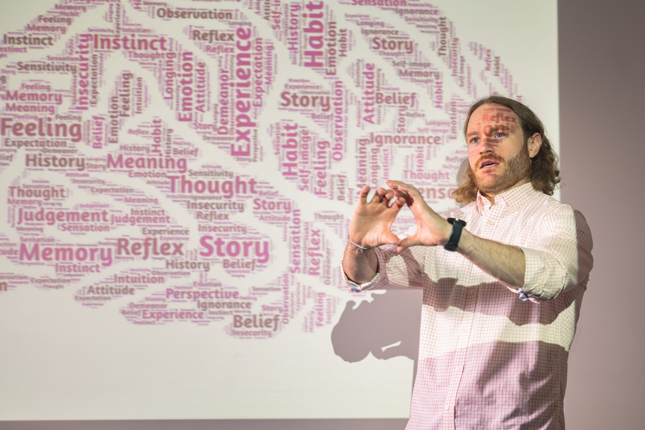 A professor of psychology presents on the brain in a class.