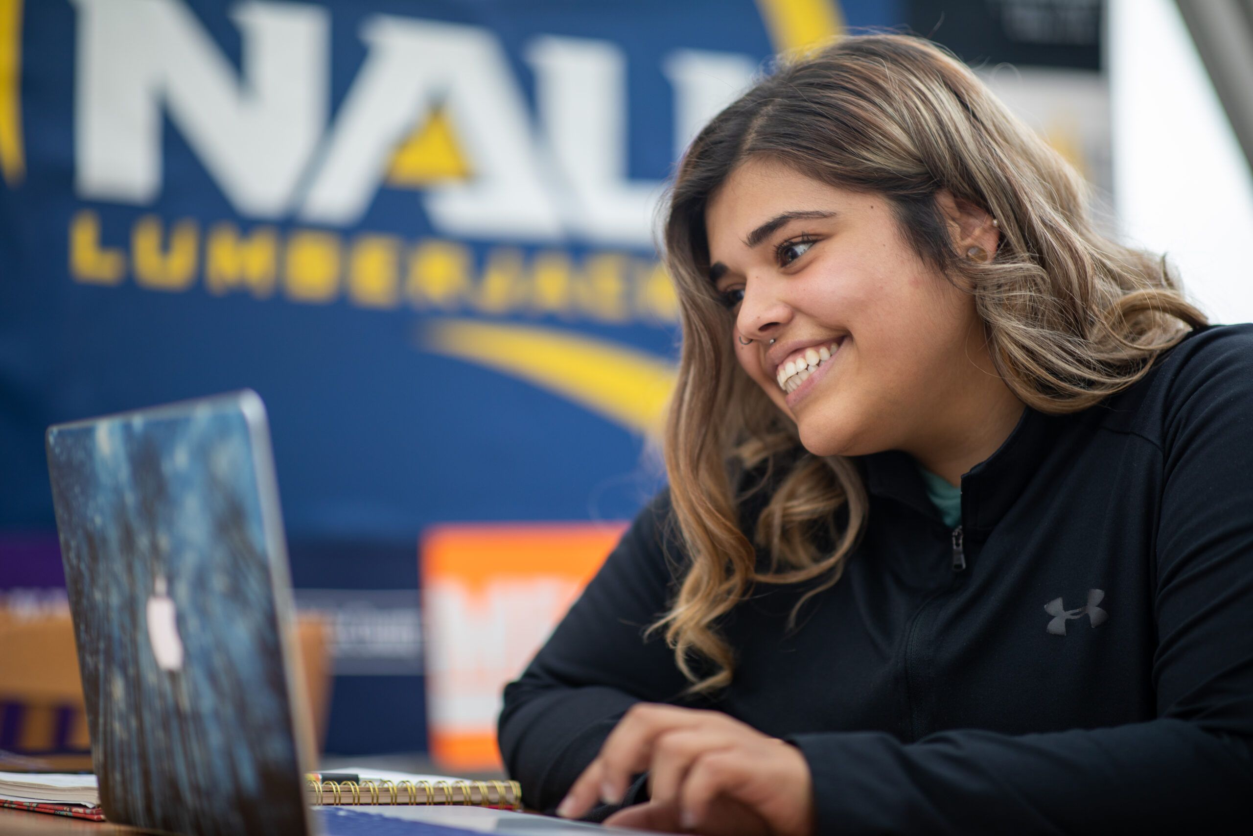 An NAU student signs up for scholarships with the help of their online advisor.
