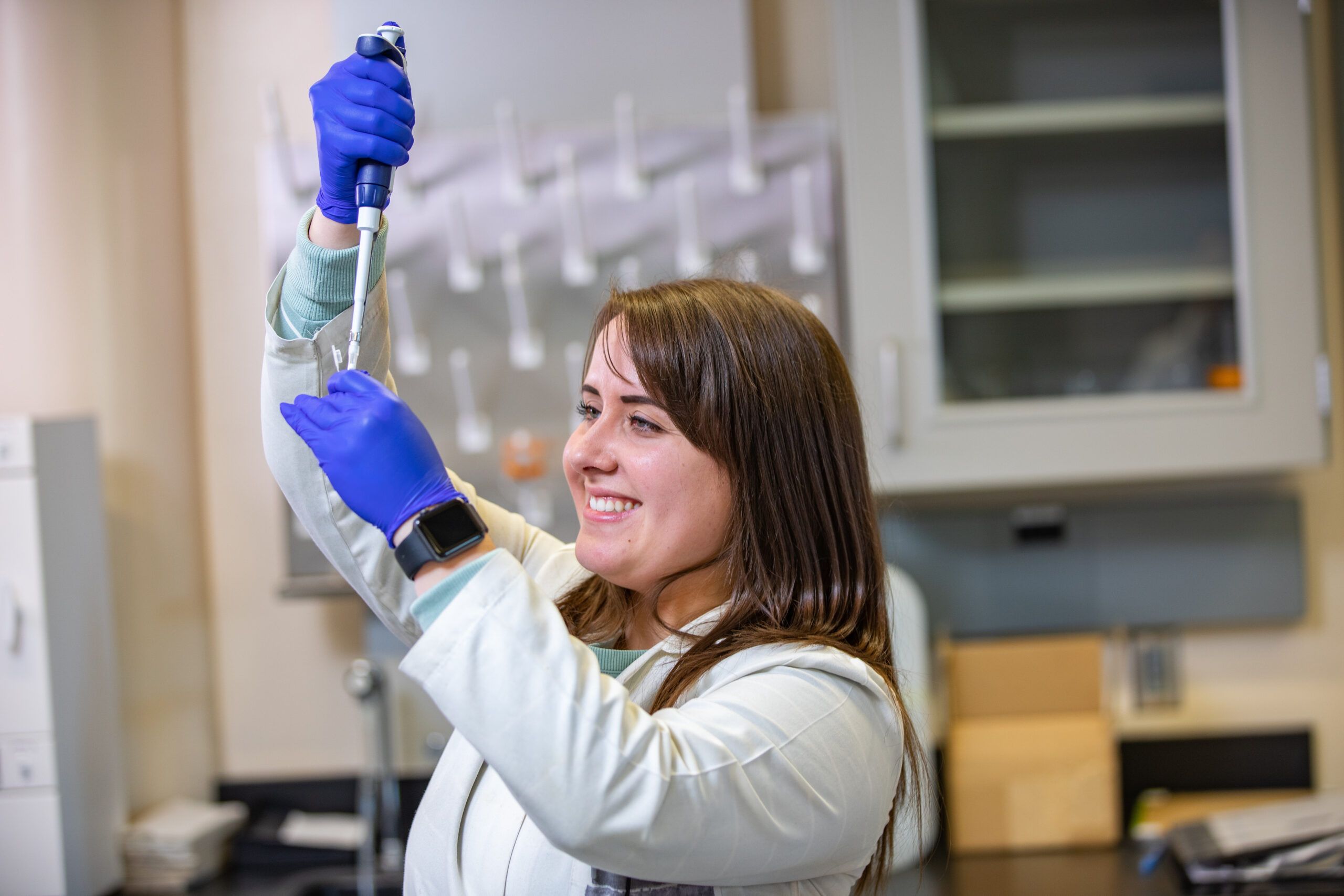 Karisma Kocos works with chemistry equipment.