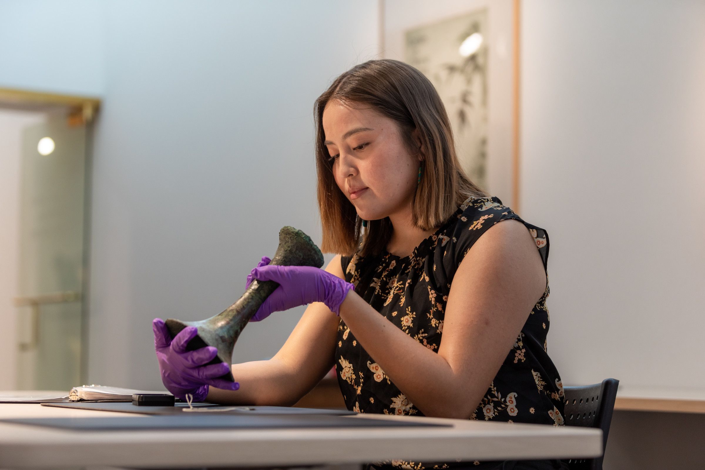NAU student examines a piece of artwork as part of the museum studies program.