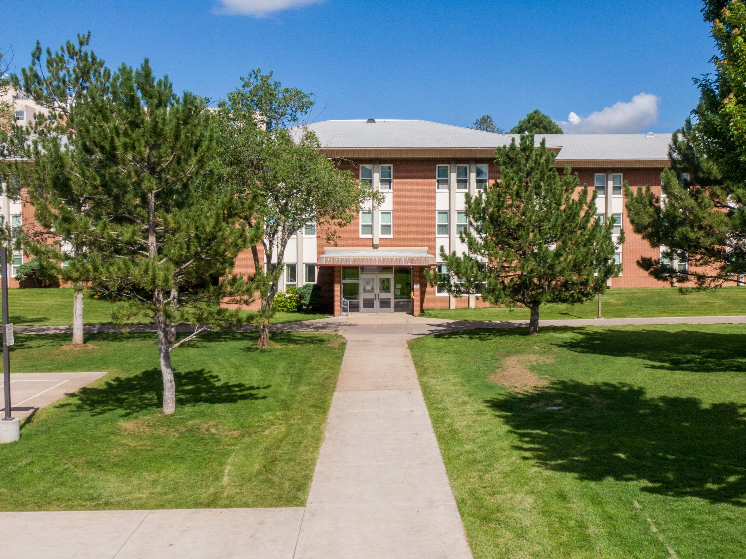 The outside of Wilson Hall, a residential hall for students, on a clear summer day at NAU Flagstaff campus.