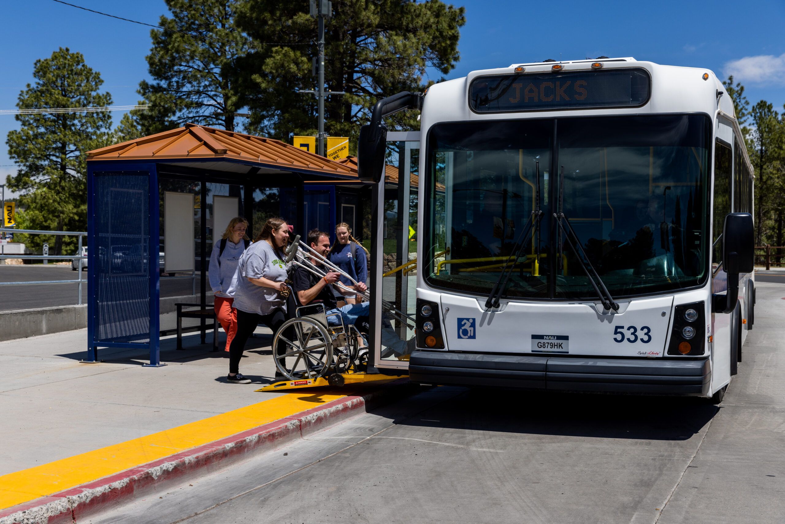 NAU Shuttle picks up students at the bus stop.