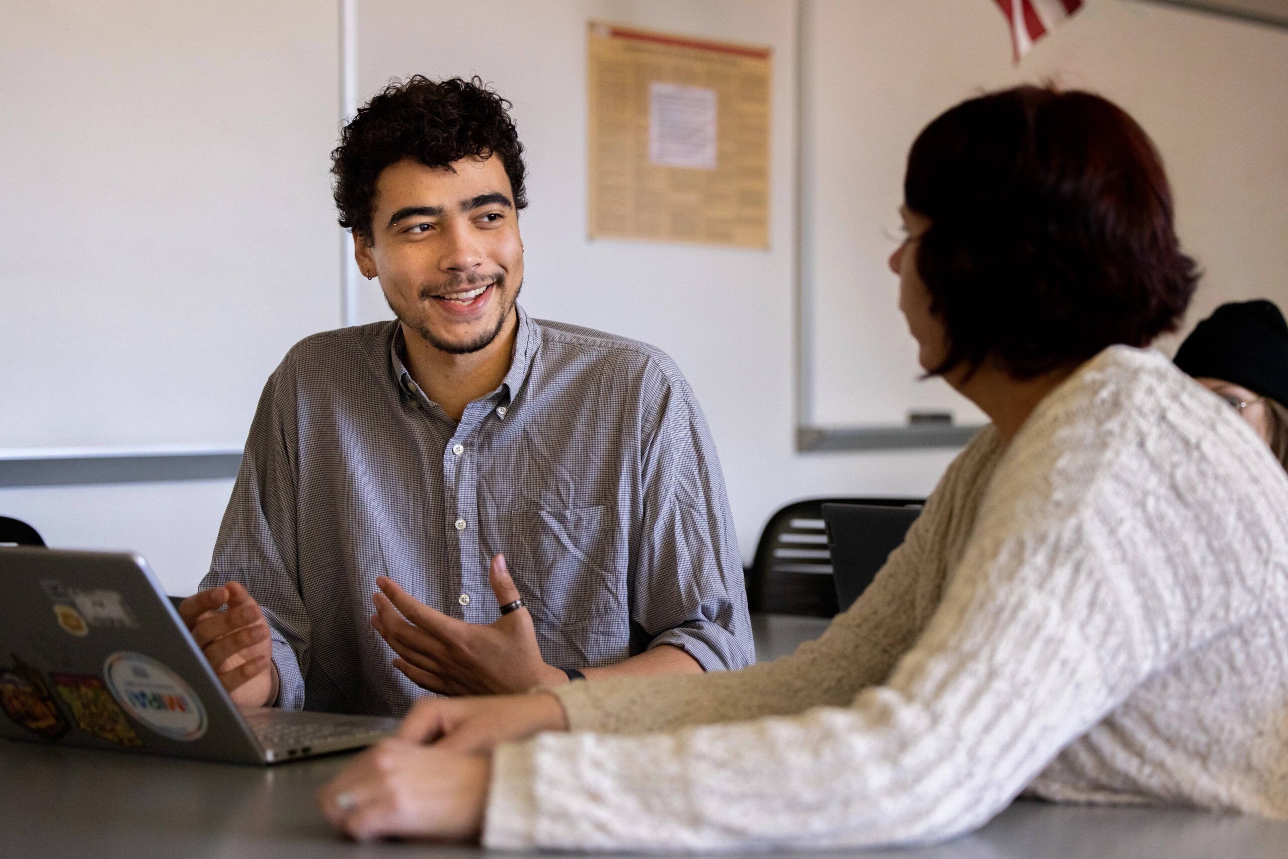 NAU student, Isaiah Raspet, smiles while chatting with his professor.