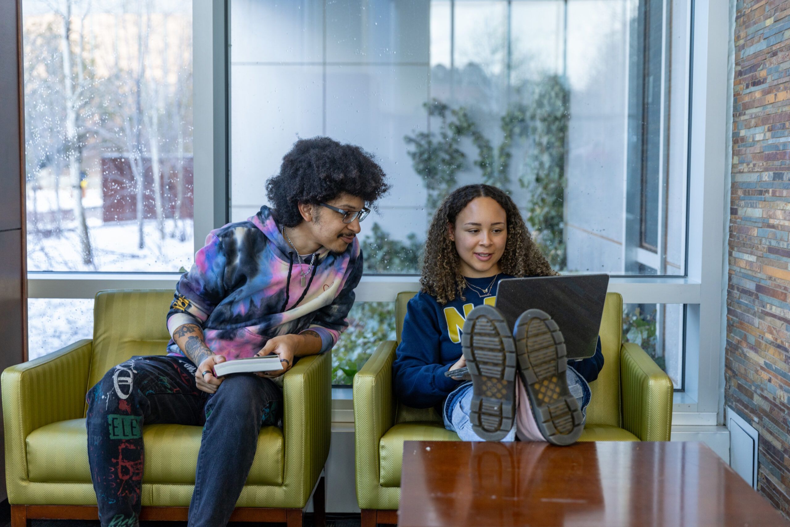 NAU students sit and work together on a laptop.