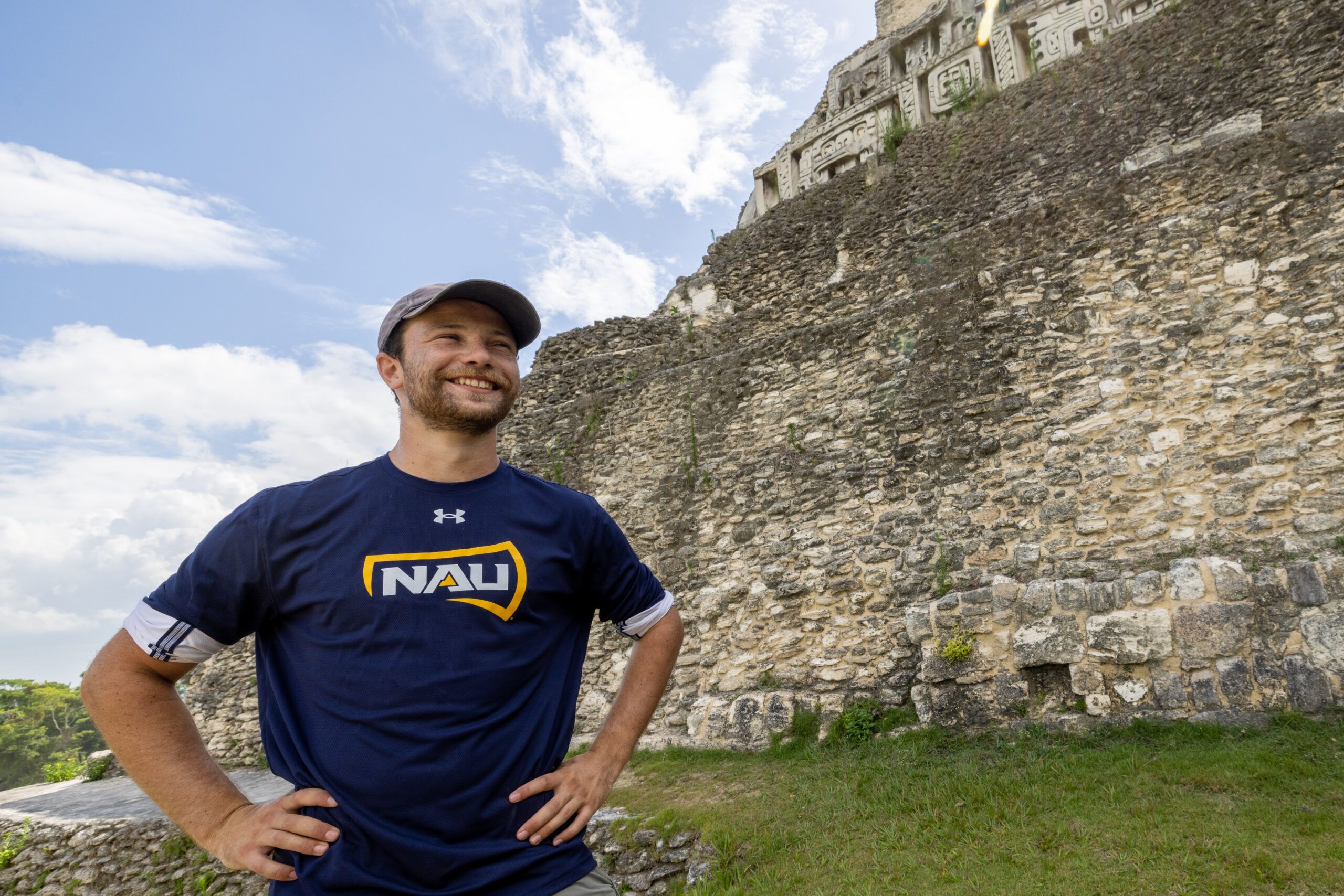An NAU archaeology student stands proudly while studying in Belize.